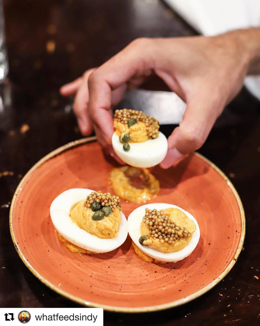 Deviled eggs topped with pickled mustard seeds