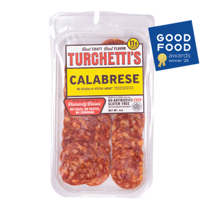 Award-winning Turchetti's Calabrese sliced salami in a clear plastic clamshell container, shown on a white background with a blue 2026 Good Food Awards badge in the top right corner.