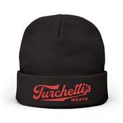 Black cuffed knit beanie with red Turchetti's script logo